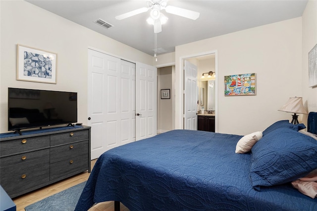 bedroom featuring ceiling fan, a closet, ensuite bathroom, and light hardwood / wood-style floors