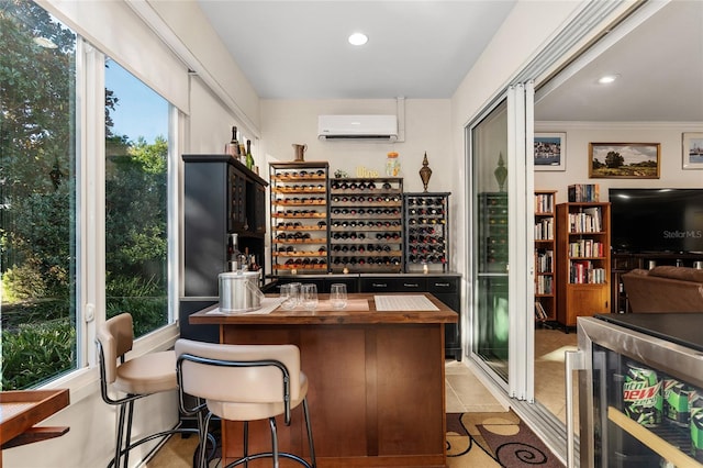 wine room featuring a wall mounted air conditioner, light tile patterned floors, ornamental molding, and a wealth of natural light