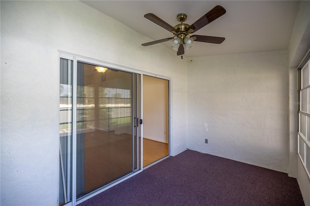 unfurnished sunroom with ceiling fan