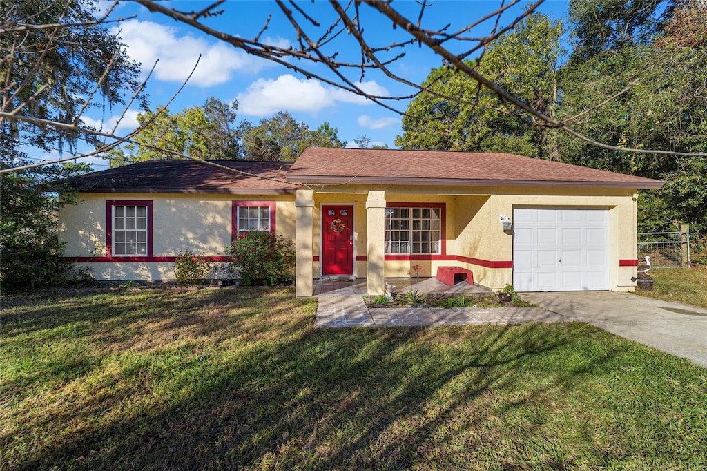 ranch-style home with a garage and a front lawn