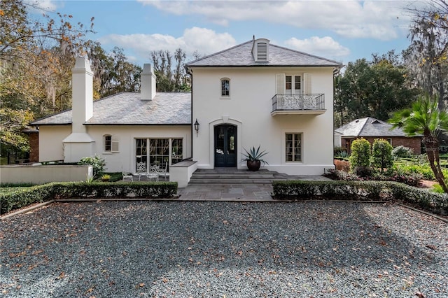 back of house with a patio area, a balcony, and french doors