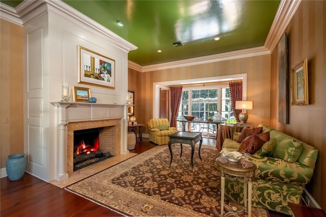 living area with hardwood / wood-style flooring and crown molding