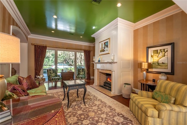 living room featuring wood-type flooring and crown molding