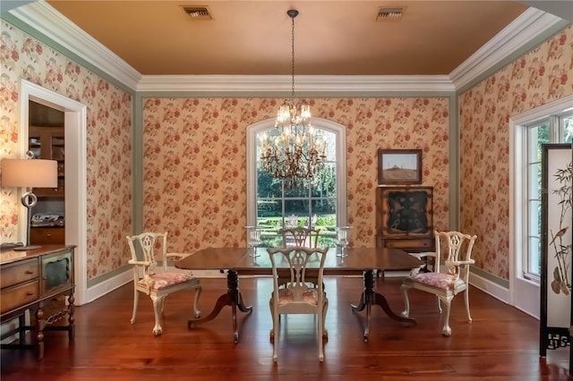 dining area featuring a chandelier, crown molding, and dark wood-type flooring