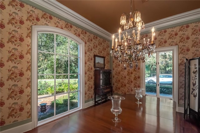 unfurnished dining area featuring dark hardwood / wood-style floors, a healthy amount of sunlight, and crown molding