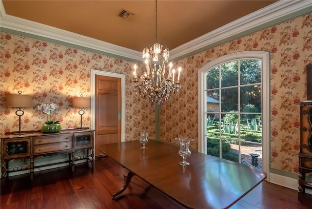 dining space with dark hardwood / wood-style flooring, crown molding, and a notable chandelier