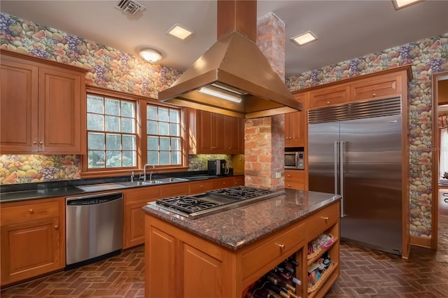 kitchen with sink, decorative backsplash, a kitchen island, island range hood, and appliances with stainless steel finishes