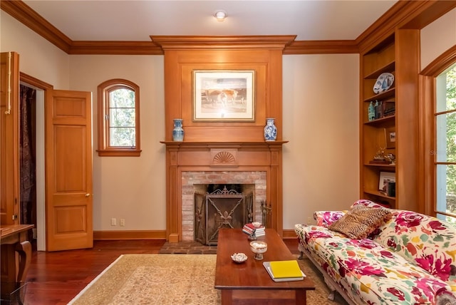 living room featuring ornamental molding, a brick fireplace, plenty of natural light, and dark wood-type flooring