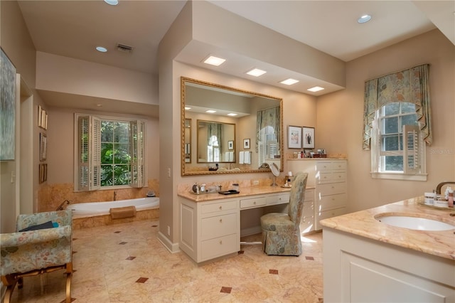 bathroom with a bath and vanity