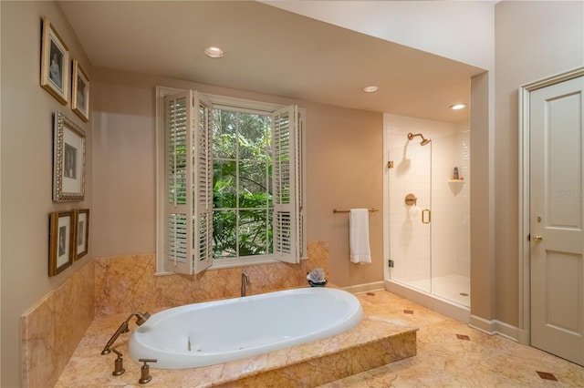 bathroom with separate shower and tub