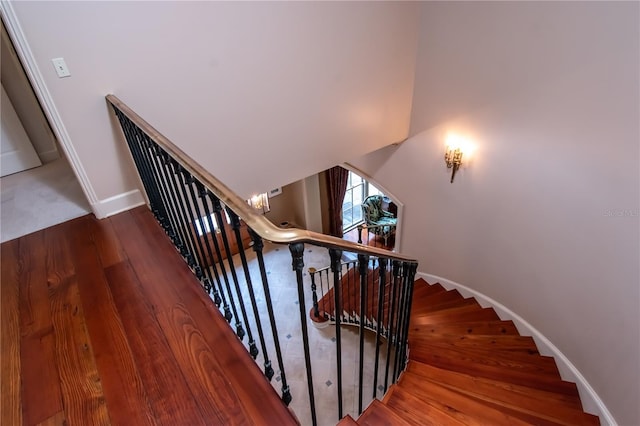 stairs with hardwood / wood-style flooring