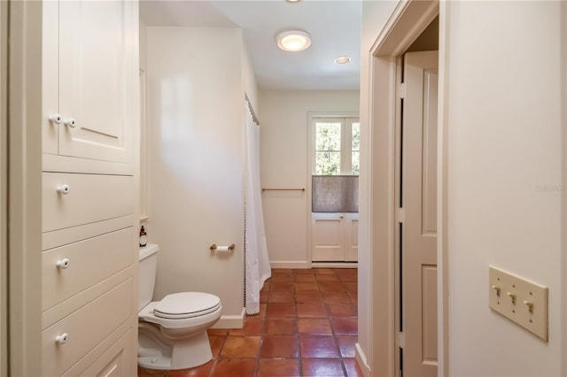 bathroom with tile patterned floors and toilet