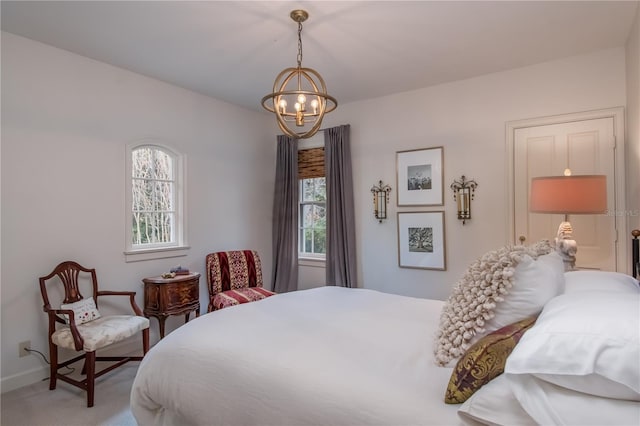 carpeted bedroom with a notable chandelier