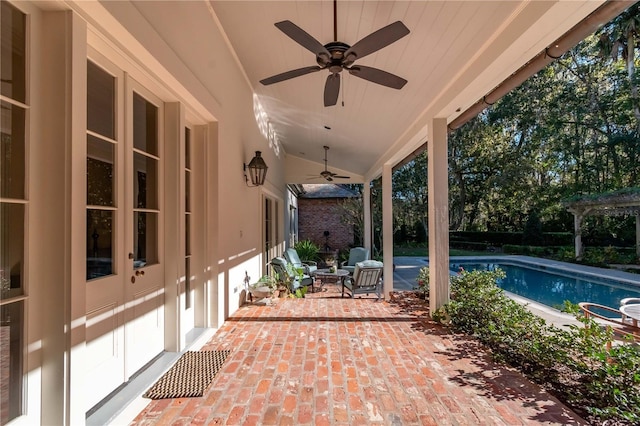 view of swimming pool featuring a patio area and ceiling fan