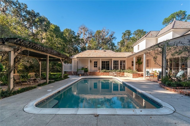 view of swimming pool featuring a patio area and a pergola