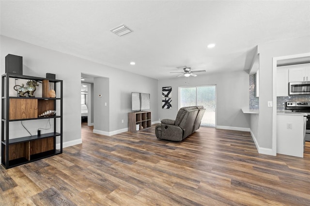 sitting room with dark hardwood / wood-style floors and ceiling fan