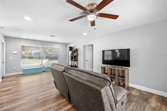 living room with ceiling fan and wood-type flooring