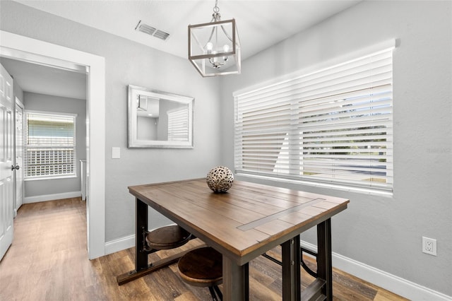 dining room featuring light hardwood / wood-style floors and an inviting chandelier