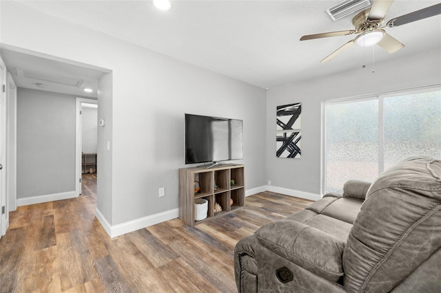 living room with ceiling fan and hardwood / wood-style flooring