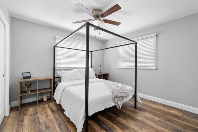 bedroom with ceiling fan and dark hardwood / wood-style flooring