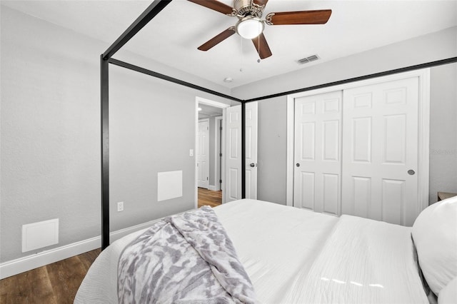 bedroom with ceiling fan, a closet, and dark hardwood / wood-style floors