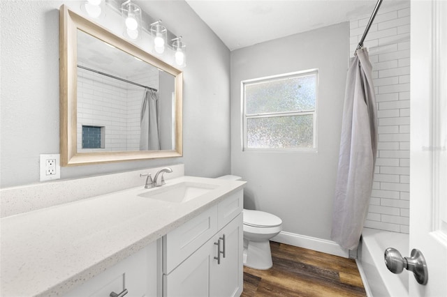 full bathroom with hardwood / wood-style floors, vanity, shower / bath combo, and toilet