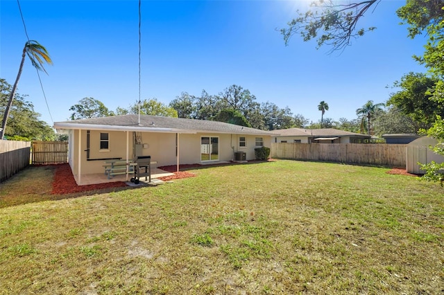 rear view of property with a lawn and a patio