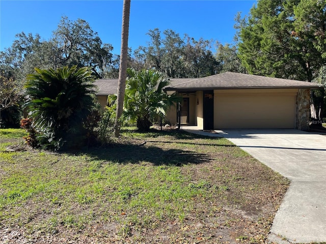 view of front of home with a garage and a front lawn