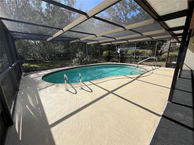 view of pool with a patio area and a lanai