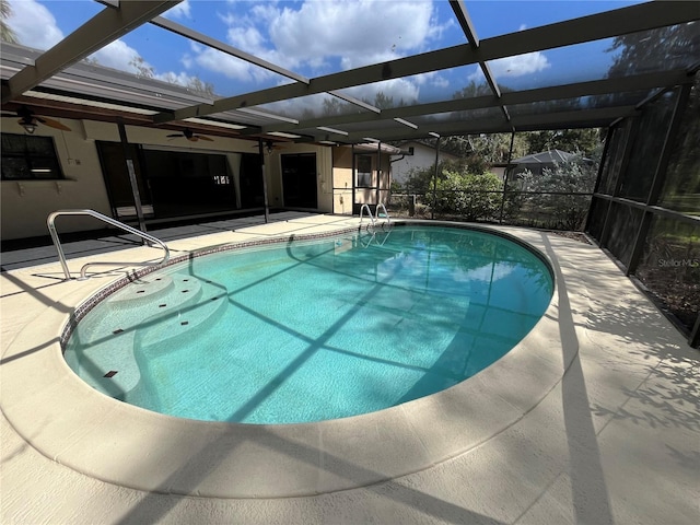 view of swimming pool featuring a lanai, ceiling fan, and a patio