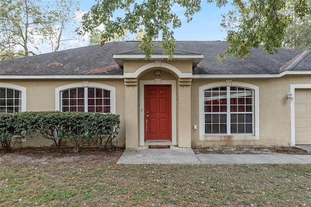 view of front of home with a garage and a front yard