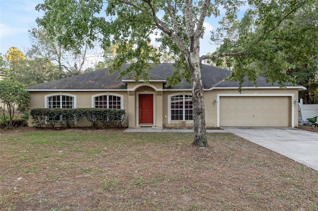 20390 SW 57th St, Dunnellon, FL 34431 - ranch-style house featuring stucco siding, a garage, concrete driveway, and roof with shingles