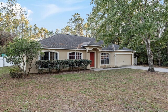 20390 SW 57th St, Dunnellon, FL 34431 - single story home featuring stucco siding, a garage, and driveway