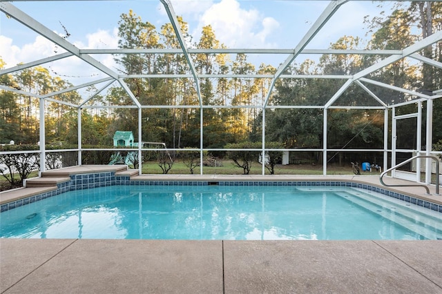 view of pool with glass enclosure