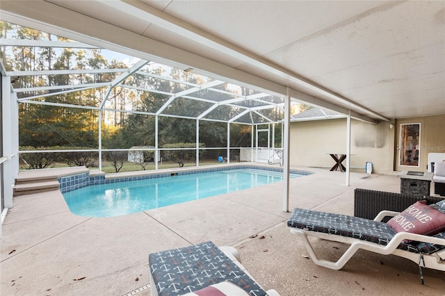 view of swimming pool with a patio area and a lanai