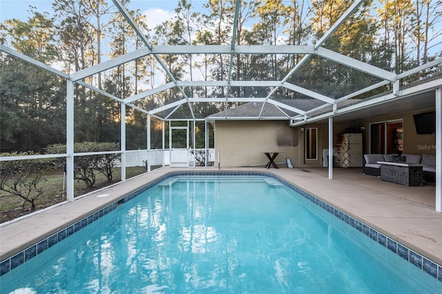 view of swimming pool featuring an outdoor living space, a patio, and glass enclosure