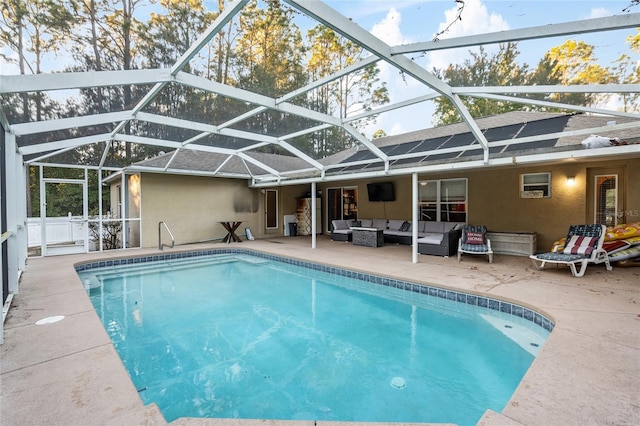 view of swimming pool with glass enclosure, a patio, and an outdoor hangout area