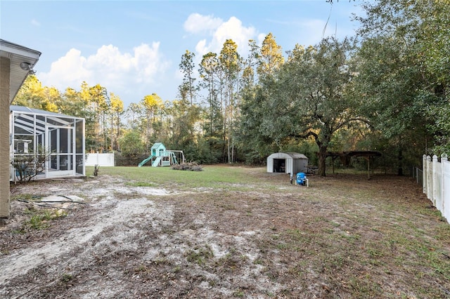20390 SW 57th St, Dunnellon, FL 34431 - view of yard featuring a playground, glass enclosure, and view of scattered trees