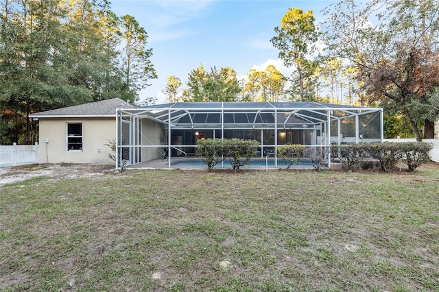 20390 SW 57th St, Dunnellon, FL 34431 - rear view of house with an outdoor pool, glass enclosure, and stucco siding