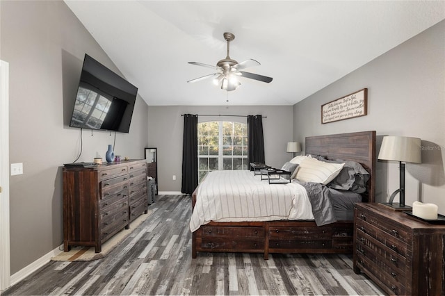 bedroom with dark wood-type flooring, ceiling fan, and lofted ceiling