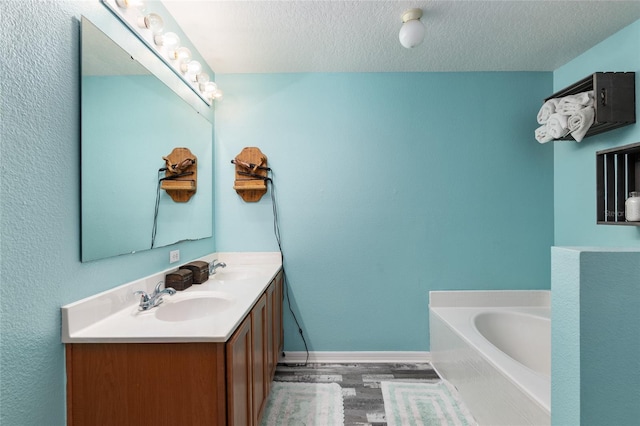 20390 SW 57th St, Dunnellon, FL 34431 - full bath featuring double vanity, wood finished floors, a bath, baseboards, and a textured ceiling