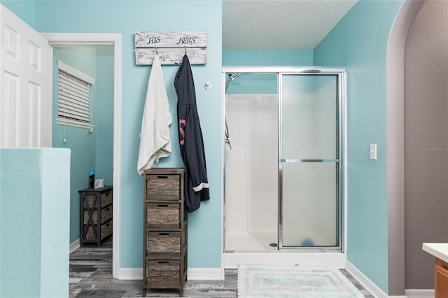 20390 SW 57th St, Dunnellon, FL 34431 - full bath featuring a stall shower, wood finished floors, vanity, and baseboards