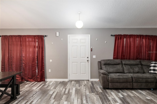 living room with hardwood / wood-style flooring and a textured ceiling