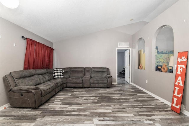 20390 SW 57th St, Dunnellon, FL 34431 - living area featuring wood finished floors, lofted ceiling, and baseboards
