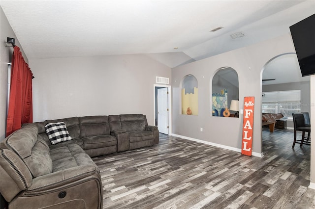 living room featuring dark hardwood / wood-style flooring and vaulted ceiling