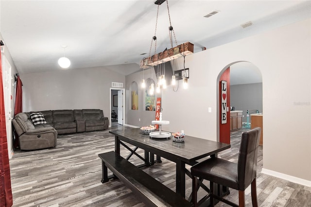 20390 SW 57th St, Dunnellon, FL 34431 - dining room featuring light wood-style flooring, arched walkways, and baseboards