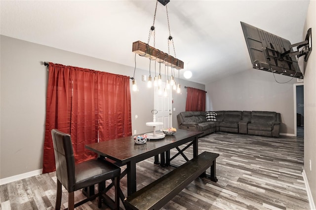 20390 SW 57th St, Dunnellon, FL 34431 - dining room featuring wood finished floors, vaulted ceiling, and baseboards