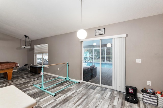 dining area featuring hardwood / wood-style flooring, billiards, and a wealth of natural light