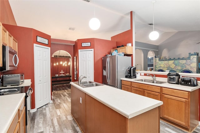 kitchen featuring sink, hanging light fixtures, and stainless steel appliances