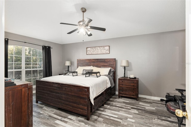 20390 SW 57th St, Dunnellon, FL 34431 - bedroom with wood finished floors, baseboards, vaulted ceiling, and ceiling fan